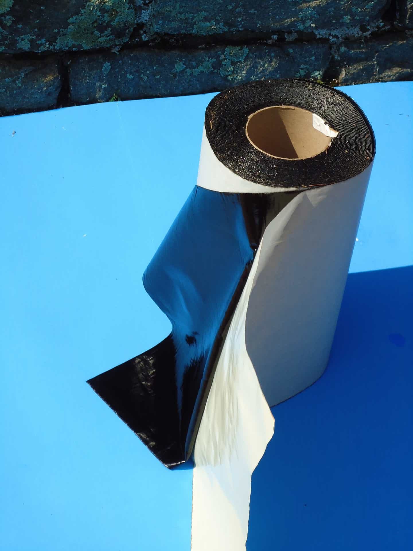 A roll of black tape is on the ground.