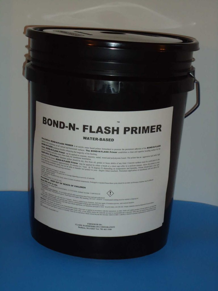 A black bucket of primer sitting on top of a table.