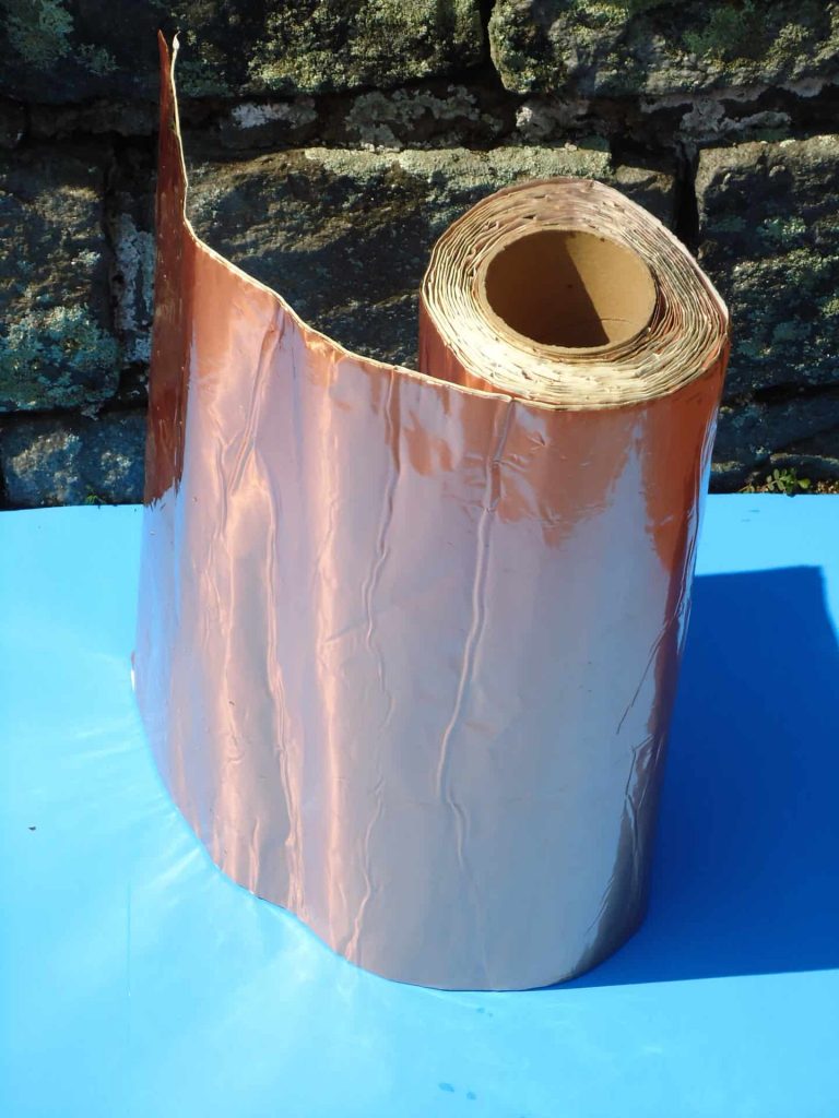 A roll of copper foil is sitting on the table.